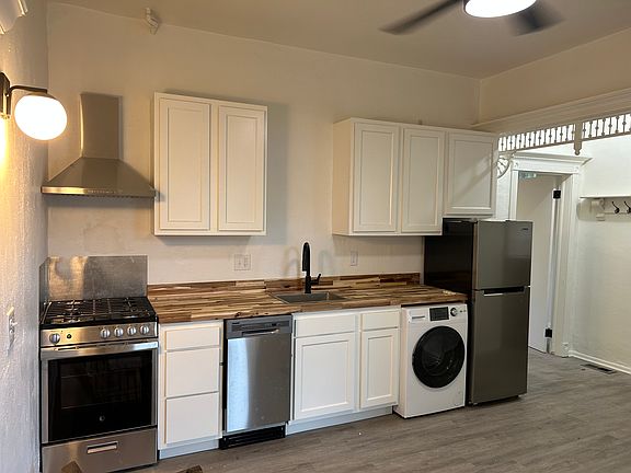 Modern stainless appliances, gorgeous butcher block countertops, shaker style kitchen cabinets.