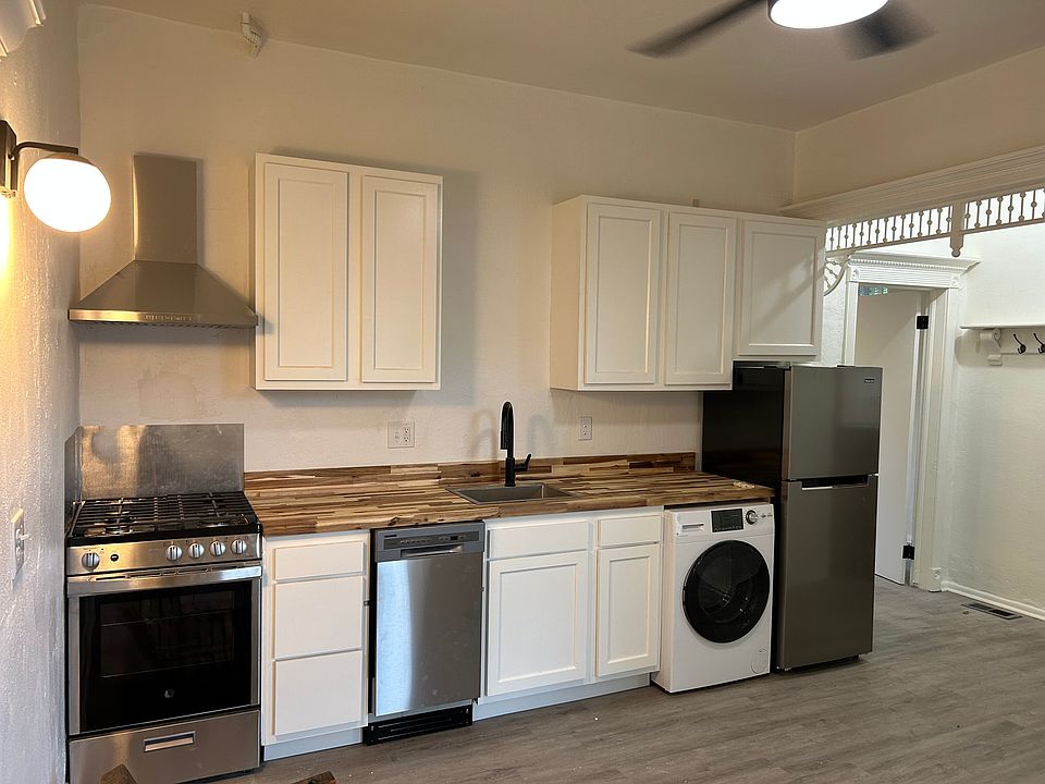 Modern stainless appliances, gorgeous butcher block countertops, shaker style kitchen cabinets.