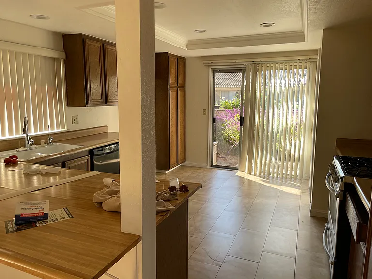 Large kitchen with plenty of cabinets and a front enclosed patio.