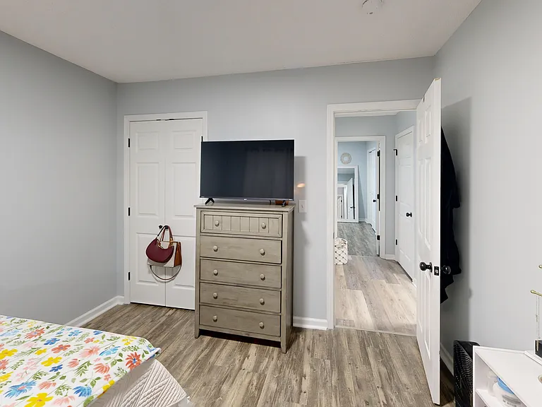 Bedroom two with reach-in closet. Photo is of a similar unit; available unit has the same floorplan. Furniture and decor not included.