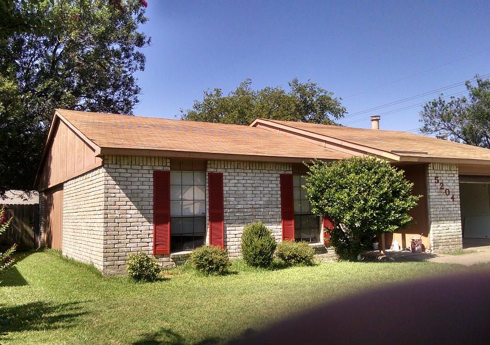 Front of house with open garage