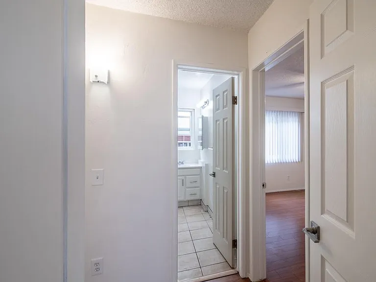 Hallway to bedrooms and bathrooms (storage closets on either side of this passage)