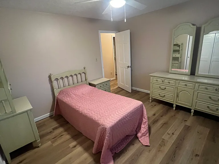 This is bedroom number two. it is furnished with a single bed there are 2 headboards two dressers, one hutch two mirrors, and night stand. Double closet! New, lighting and freshly painted!