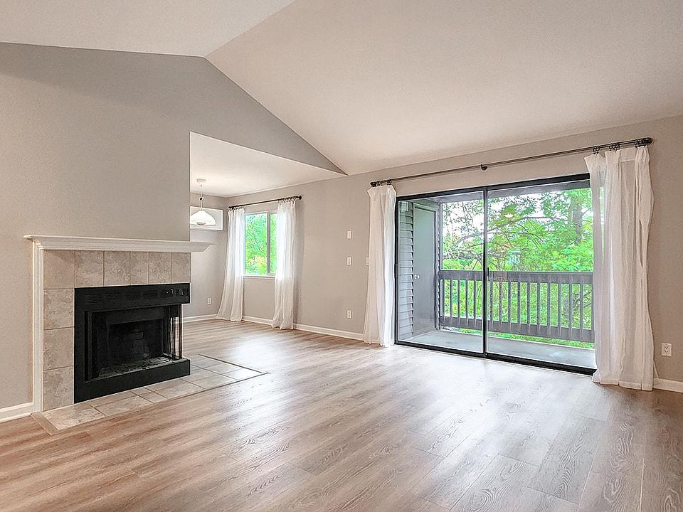 Open living room with double glass sliding doors onto private balcony