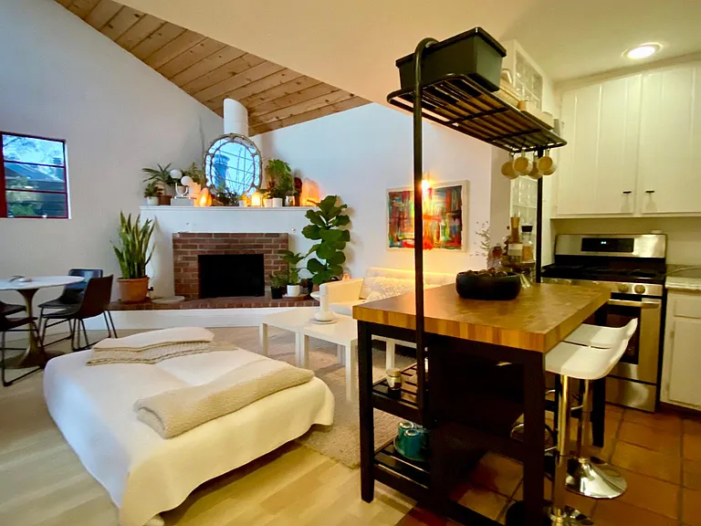 Highlighting tiled kitchen and permanent kitchen island to optimize the kitchen space.