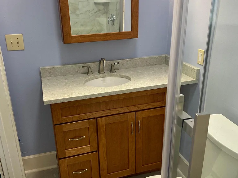 Completely renovated bathroom with new cabinetry and shower