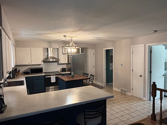 Spacious kitchen with island & peninsula
(Refrigerator not included, but will be replaced with another one)