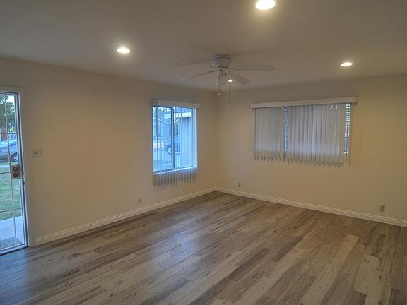 Living Room showing brand new floor tiles, recessed lights and ceiling fan.