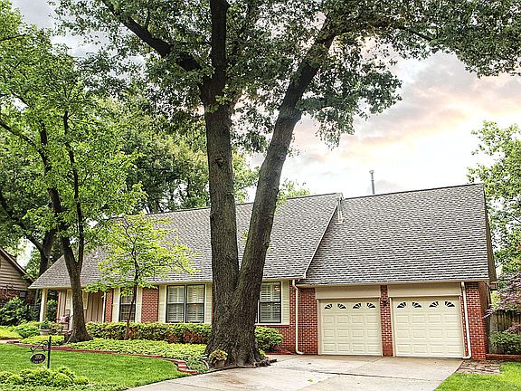 The mature trees, both in front and back, provide shade and beauty year round.