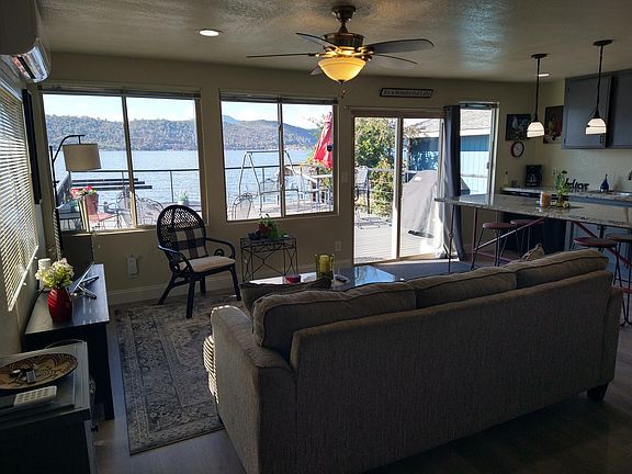 Living room area of the house , with kitchen on the right side of photo. Great views of the lake!
