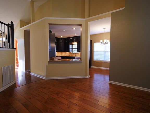 Great room looking into the kitchen. Plenty of room for stools at the counter for homework or meals.