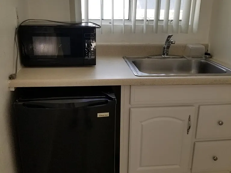 kitchen sink with garbage disposal, small refrigerator & microwave or 2-burner stove