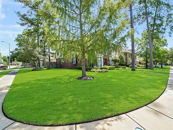 This home sits on a corner lot offering beautiful green space and a driveway at the back of the home. The extended 2-car garage has painted floors for easy cleaning and upkeep, tool cabinets & formica work top, as well as a power roof vent to keep th