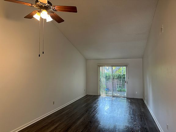 Living room with slider exiting to a private patio/garden area. Design your own space for your private spot for relaxing .