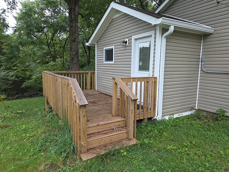 Side porch where you can enter into the laundry room.