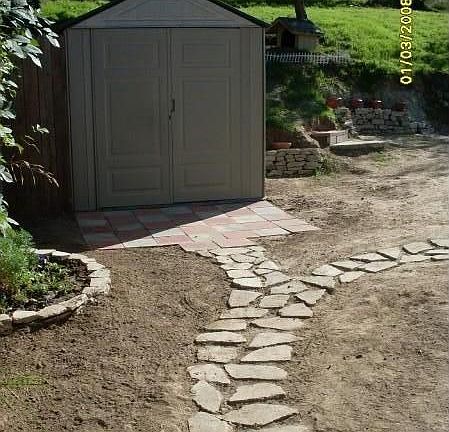 Path to the back yard and rubermaid shed,