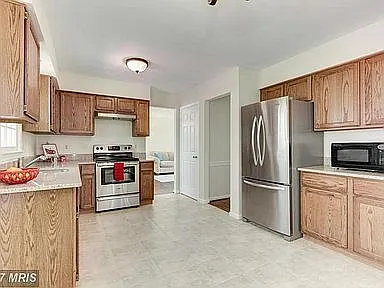 Kitchen facing Dinning Room. Shows door to basement.