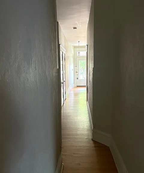 Hallway from kitchen entrance looking toward the front door