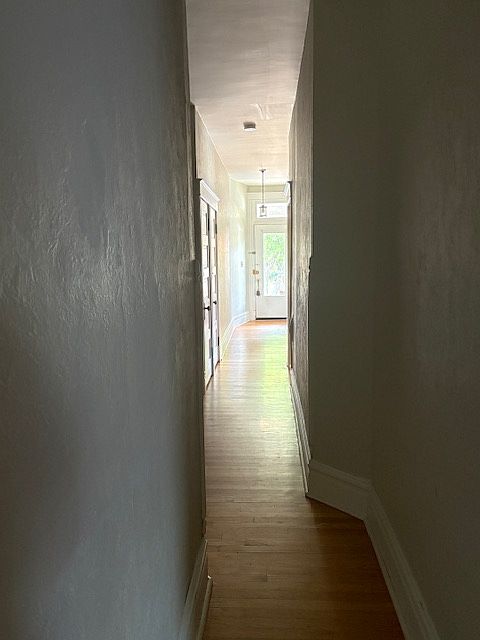 Hallway from kitchen entrance looking toward the front door