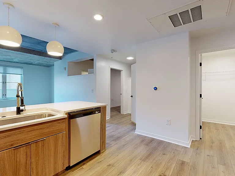 Apartment dining and living room with wood-style flooring.
