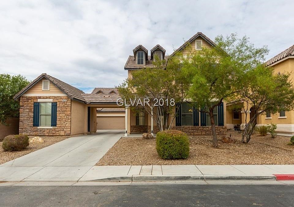 FRONT OF HOUSE WITH STONE ACCENTS*LONG DRIVEWAY WITH GARAGE SET IN THE BACK