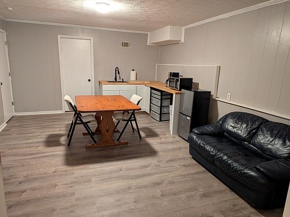 Kitchen/den area, tv is to the left of pic. Extra space along that left wall for other furniture you may want to bring in.