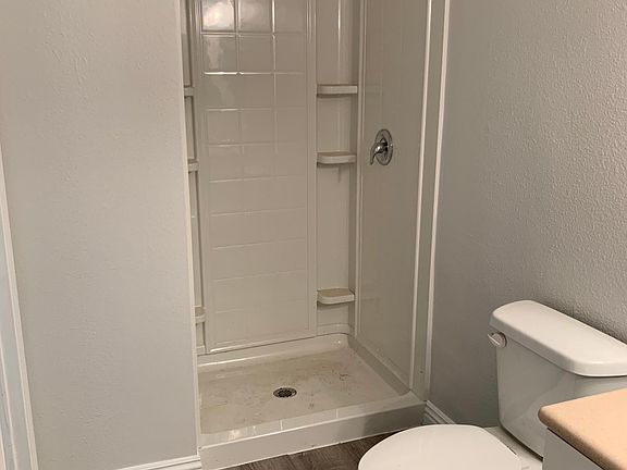 Renovated downstairs bathroom, with newly renovated shower stall, cabinets and flooring.