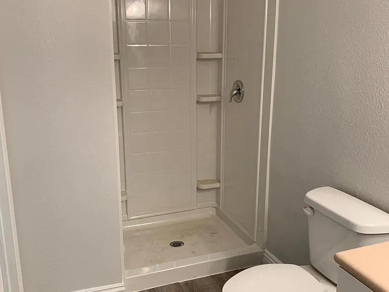 Renovated downstairs bathroom, with newly renovated shower stall, cabinets and flooring.