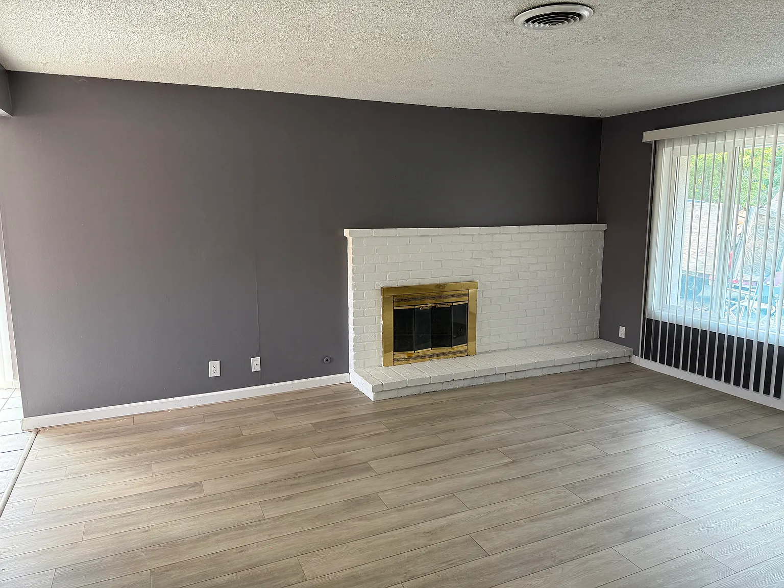Living room facing hallway from bedroom and bathrooms