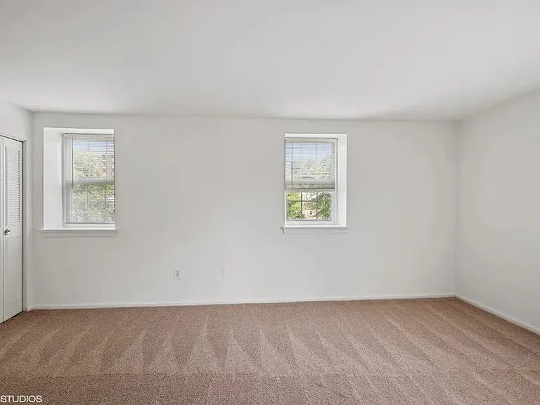 Bedroom with plush carpeting and large closets
