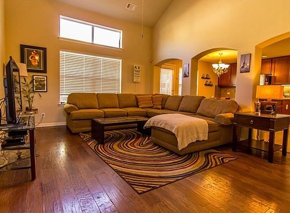 Living room with wood floors and high ceiling