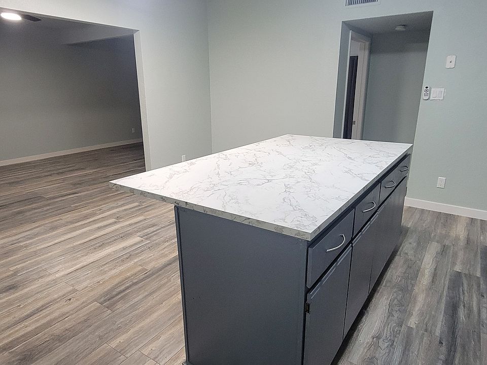 Kitchen - you can see entry into the living room and that there is a dishwasher and full-size refrigerator.