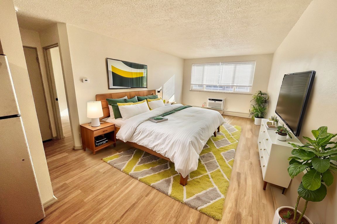 Experience luxury and comfort in this stylish bedroom with vibrant decor and natural light.