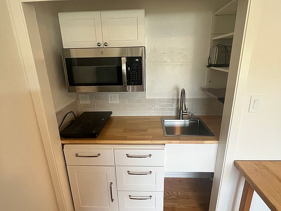 Brand new kitchenette, refrigerator microwave with vent and surface light, two burner induction cooktop, toaster and toaster oven available, plenty of cabinets and spray faucet with tile backsplash