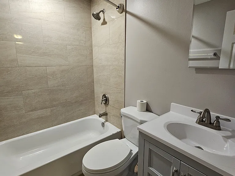 Fully remodeled upstairs bathroom with new waterproof tile floors in golden ochre, cream marble shower tile, new vanity with great lighting and relaxing ambiance