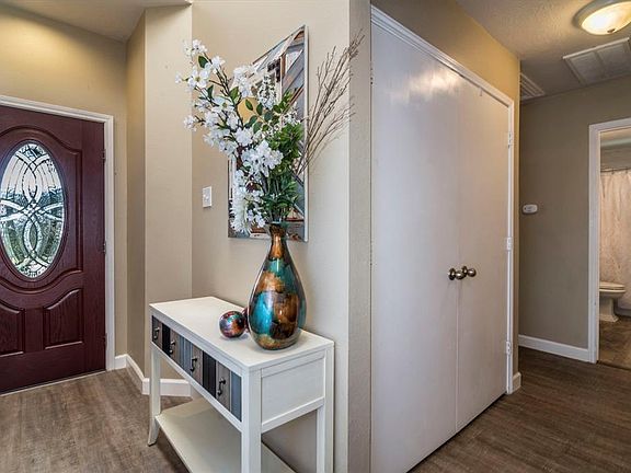 Pride of ownership shows throughout this home. Behind the double doors is the utility area. There is also a skylight at the entrance.