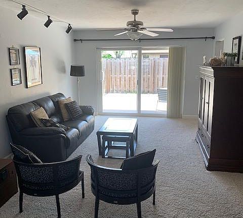Living area featuring an entertainment center with stereo and tv hidden in beautiful wood cabinet.