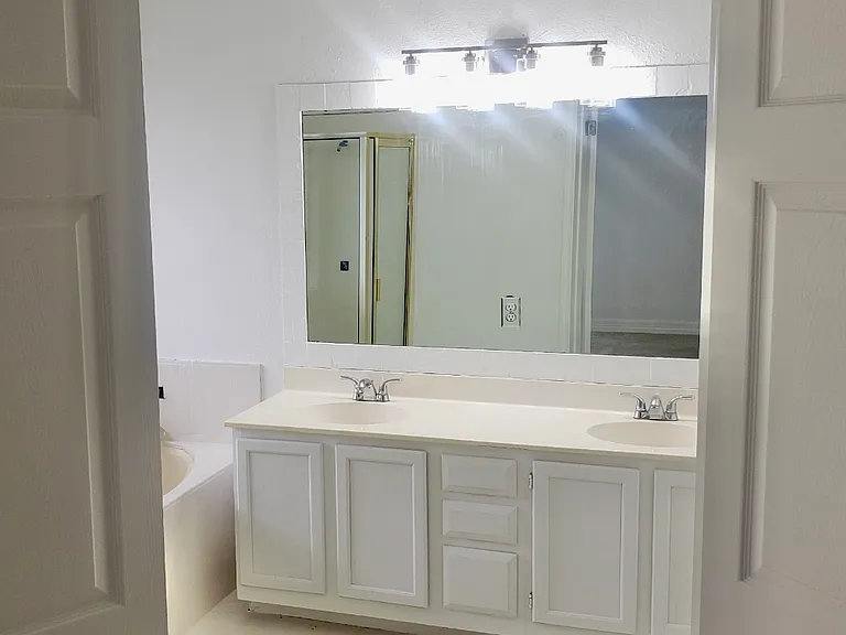 Master bathroom with double vanity, separate tub and shower.