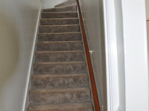 Stairs going up to bedrooms and bathroom