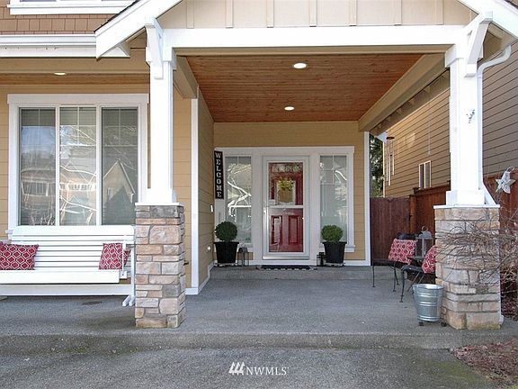 Sip ice tea in your wicker chairs in the awesome summertime on this covered over-sized front porch!