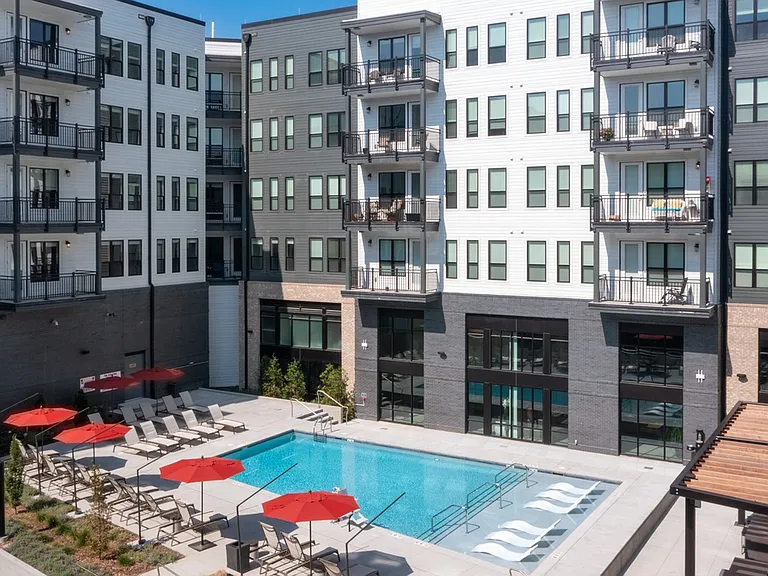 Enjoy resort-inspired living with our courtyard pool, shaded pergola lounge, and rows of sun-soaked loungers.
