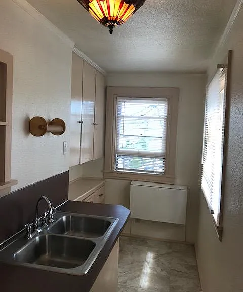 Separate kitchen with sunny windows-