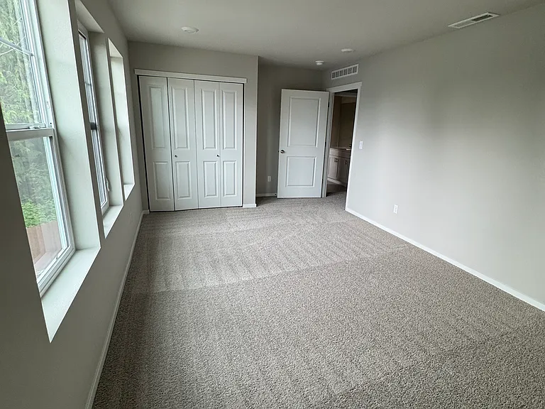 4th bedroom / bonus room. Overlooks front of home, open space, and driveway. Located over garage.