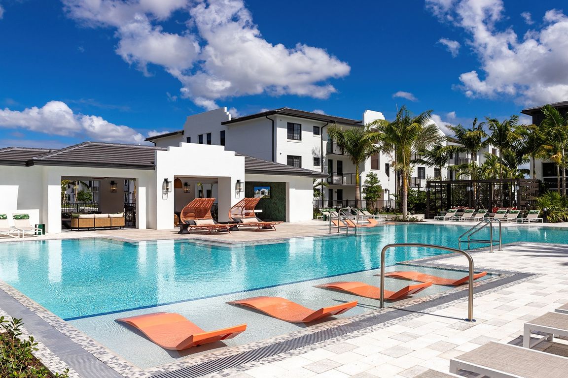 Relax by the shimmering pool at your new community