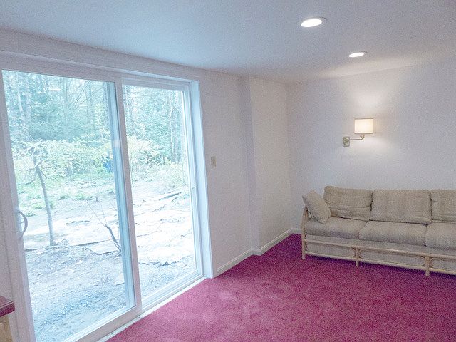 Living room looking toward sliders that open into the garden