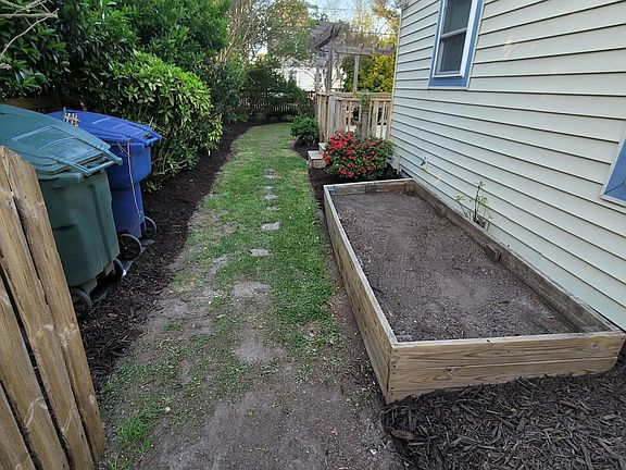 Left side yard behind fence gate