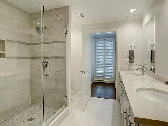 This third bath is conveniently located just outside the study. The over-sized tiled shower is enclosed with seamless glass doors and the counters have been upgraded to stylish and practical quartz stone.