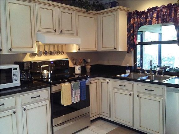 Kitchen with natural light from window  viewing porch and back yard