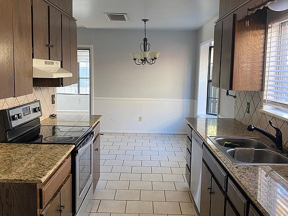 Kitchen with granite countertops. Refrigerator, stove/oven and dishwasher provided. Washer & dryer hook ups are inside.