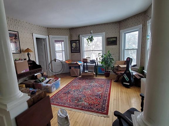 Facing 2nd living room with access to small bedroom and dark floor 3 season porch.